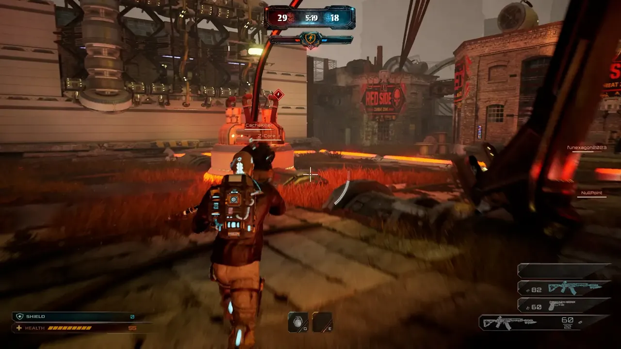An operator carrying an energy backpack approaches a marked capture zone beside industrial pylons